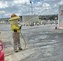 A person in a yellow helmet holding a hose
AI-generated content may be incorrect.